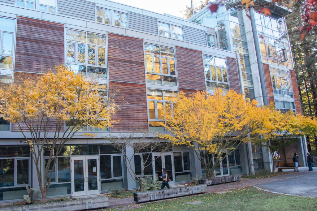 Humanities building on the UCSC campus featuring fall colors on the trees that surround the area.