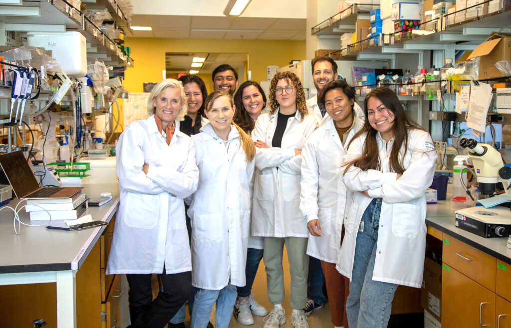 A group of researchers in a lab standing together.