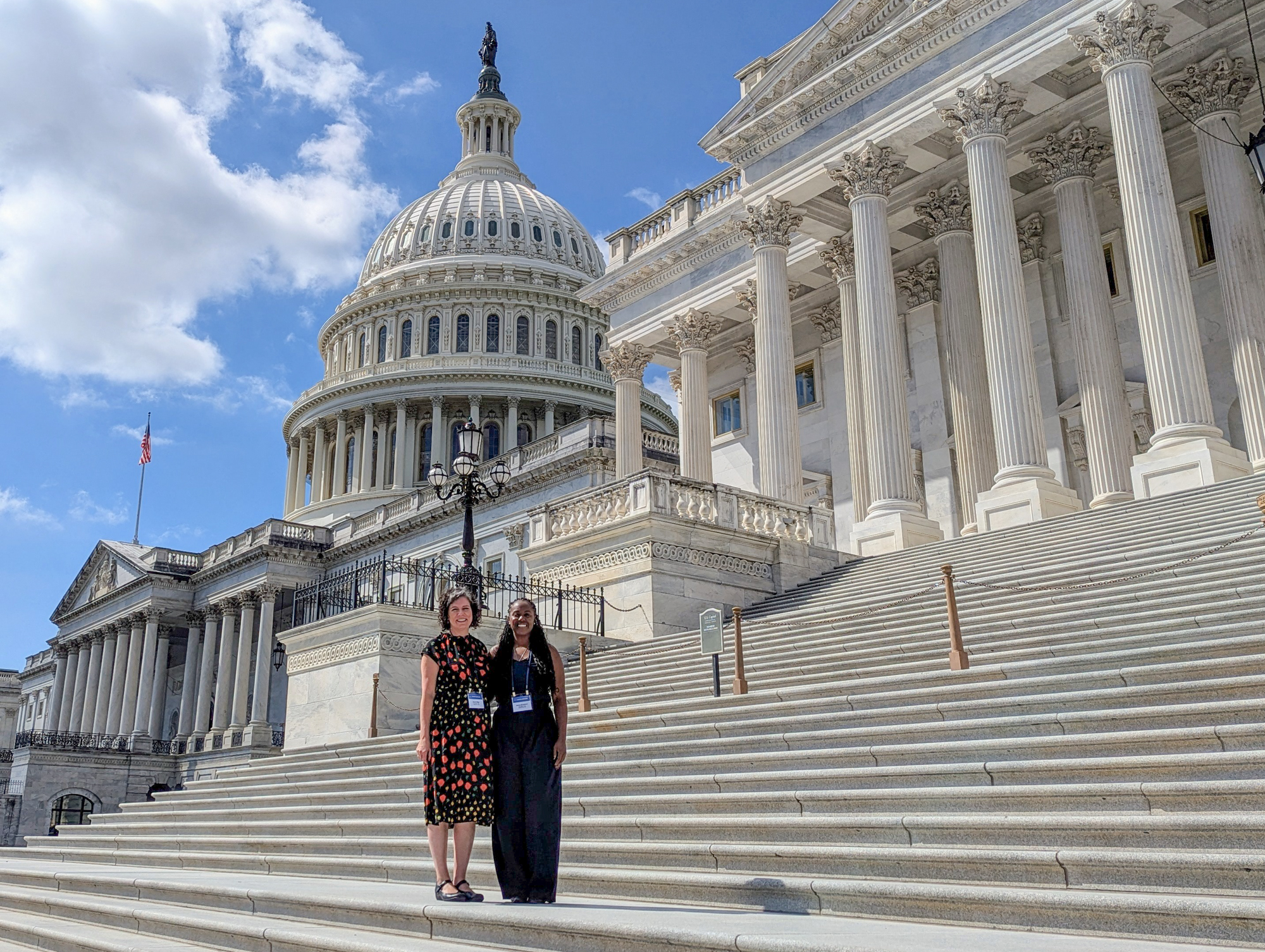 Karen Miga and Krizia Chambers on steps near the Capitol Building in Washington, D.C.
