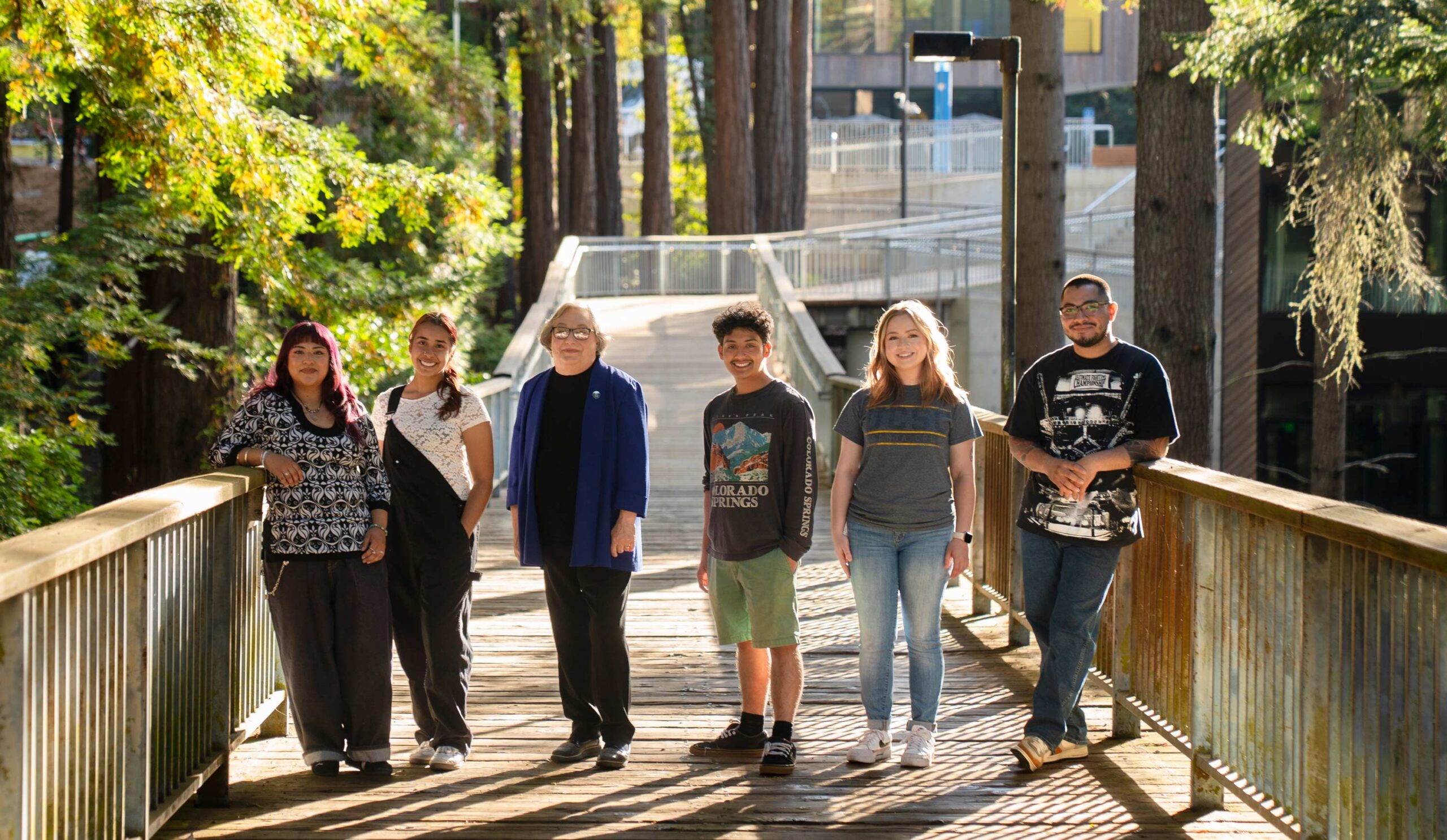 Chancellor and students stood on the Krege College bridge
